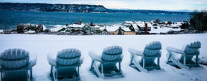 5 Blue Hamilton Adirondack chairs covered in snow zoomed in. 