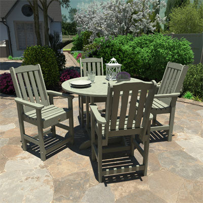 Light green round 5-piece Lehigh counter height dining set on paved stone patio. 
