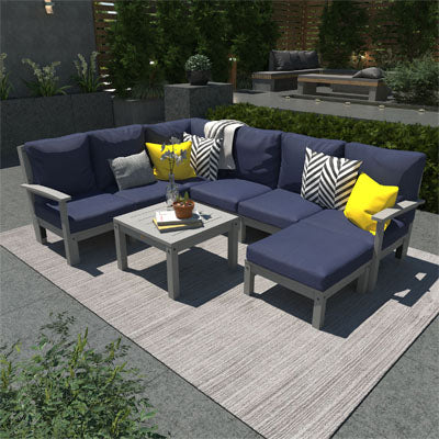 Deep seating furniture set with navy blue cushions and gray frames in outdoor patio area. 