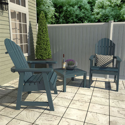 Two blue Hamilton deck chairs and side table on patio. 