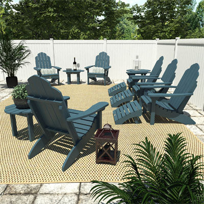 Blue Westport Adirondack chairs, ottomans, and tables in a poolside area.  