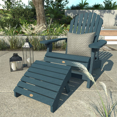 Blue King Hamilton Adirondack chair and ottoman by a poolside with pillow on the seat. 