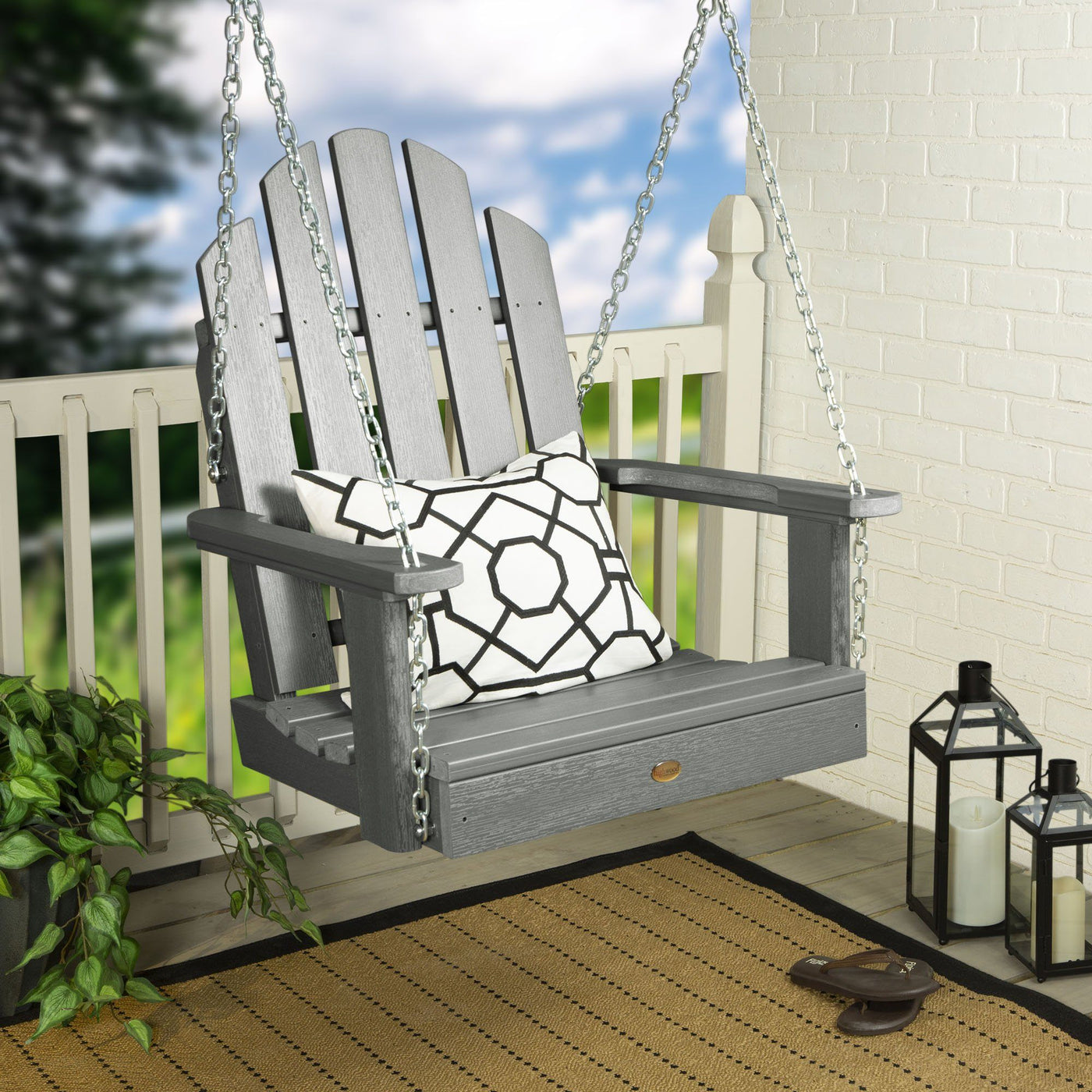Gray Single Seat Westport Swing on porch with pillow