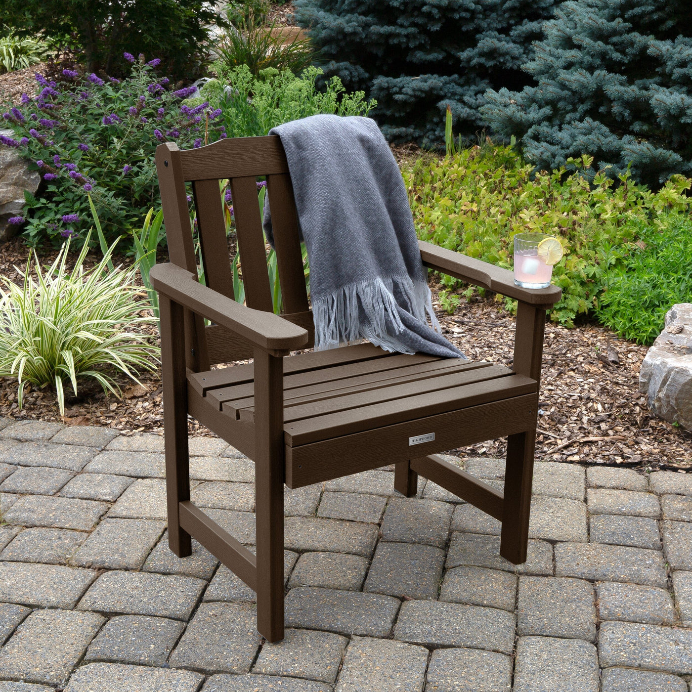 Brown Lehigh garden chair on patio with blanket and cup