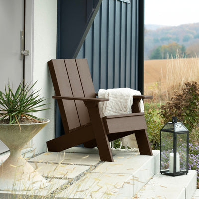 Brown Italica Modern Adirondack chair on porch with blanket and lantern