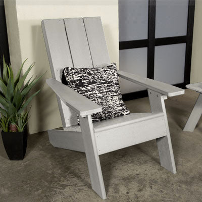 Light gray Italica Modern Adirondack chair on front porch with pillow. 