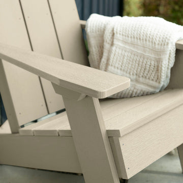 Close up of Whitewash Italica Modern Adirondack Chair with blanket