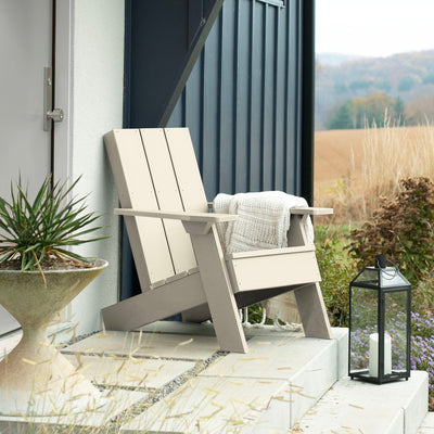 Whitewash Italica Modern Adirondack chair on porch with blanket and lantern
