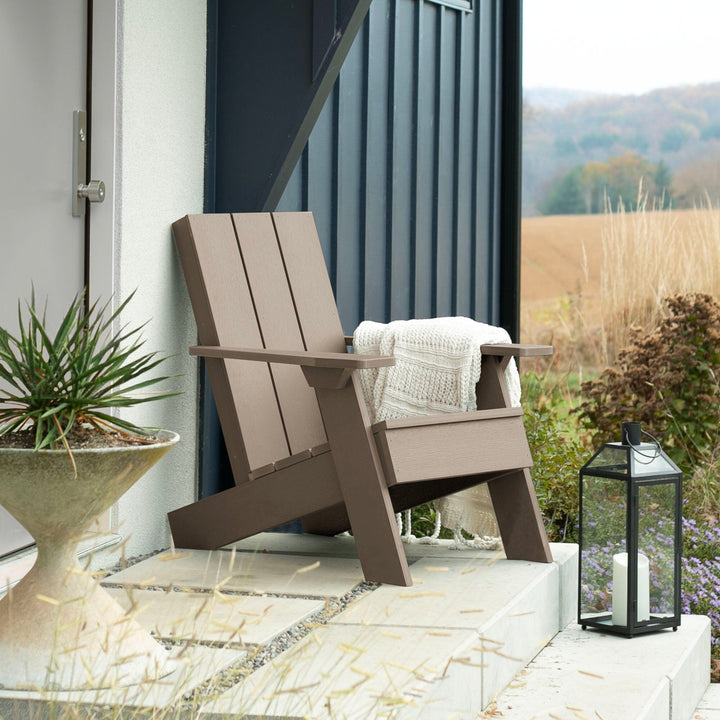 Light brown Italica Modern Adirondack chair on porch with blanket and lantern