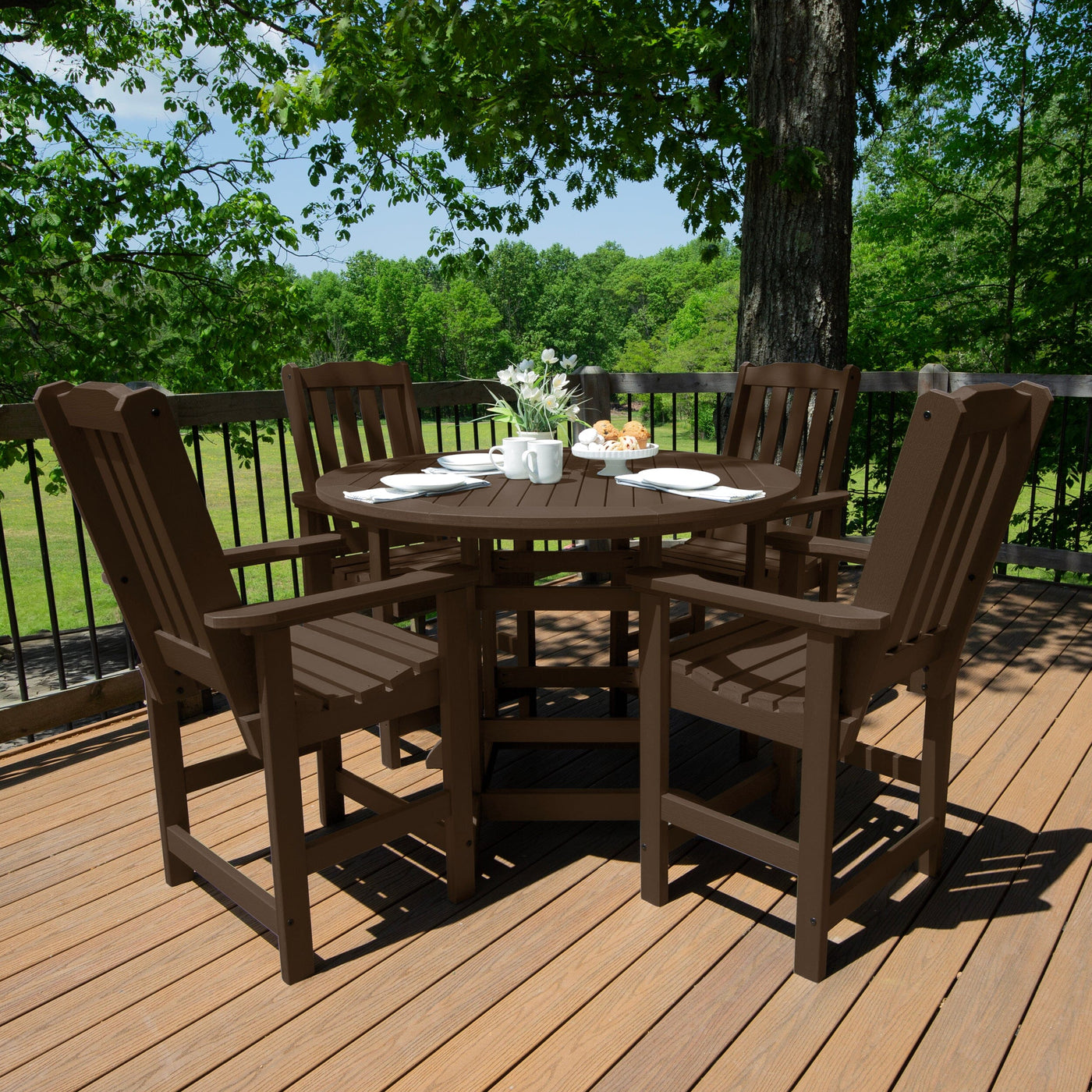 Brown round dining set on a wooden deck set for a meal