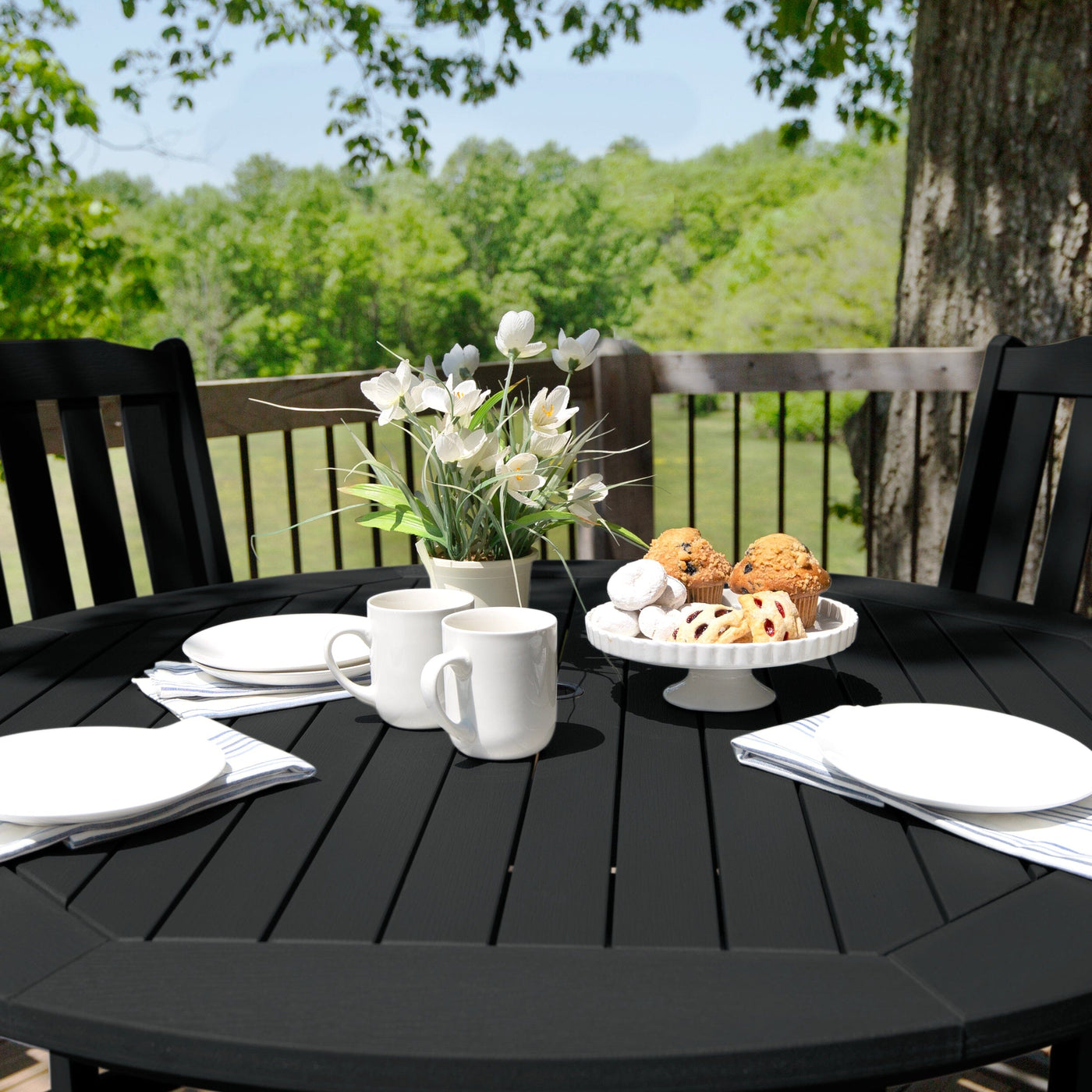 Round dining table set in black color with table setting
