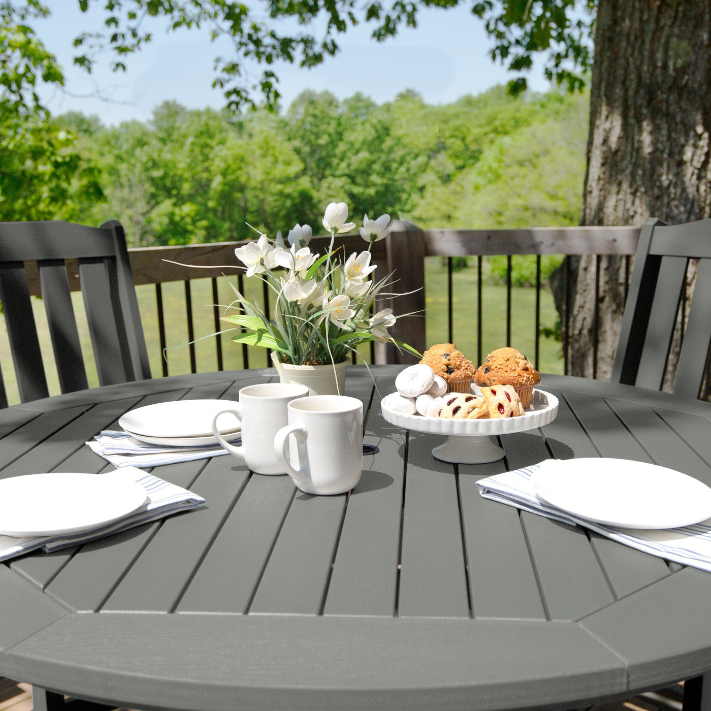 Round dining set on deck with dishware