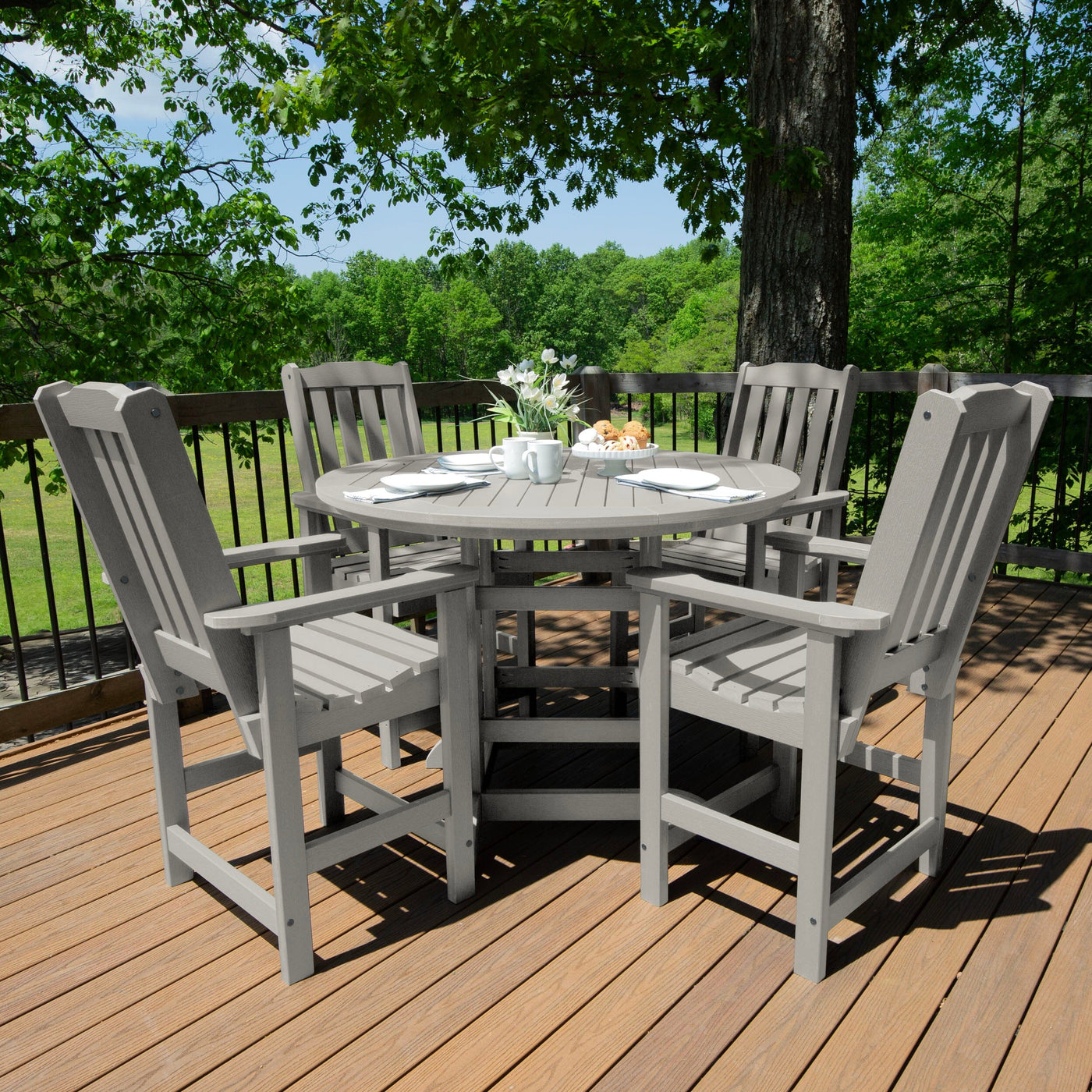 Light gray/white round dining set on deck