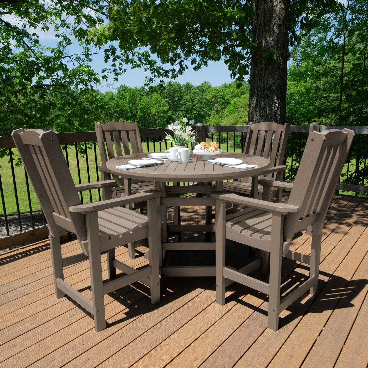 Beige round dining set on deck with four chairs