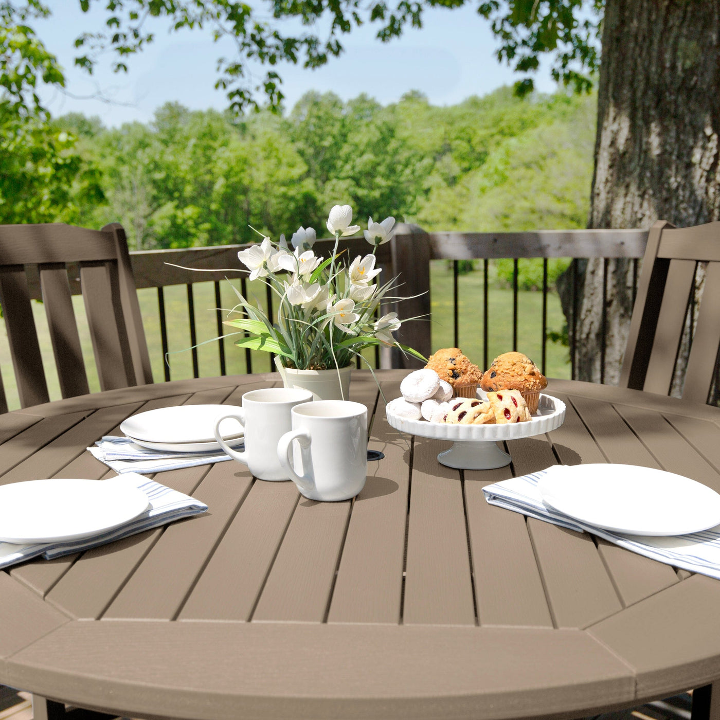 Beige/gray round dining set on deck with plants