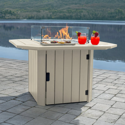 Whitewash Oasis Fire Table with lit flame and lake in background
