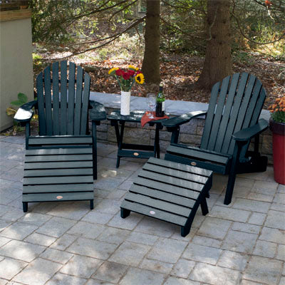 2 Dark blue Hamilton Adirondack chairs with ottoman and folding side table with flowers and wine.