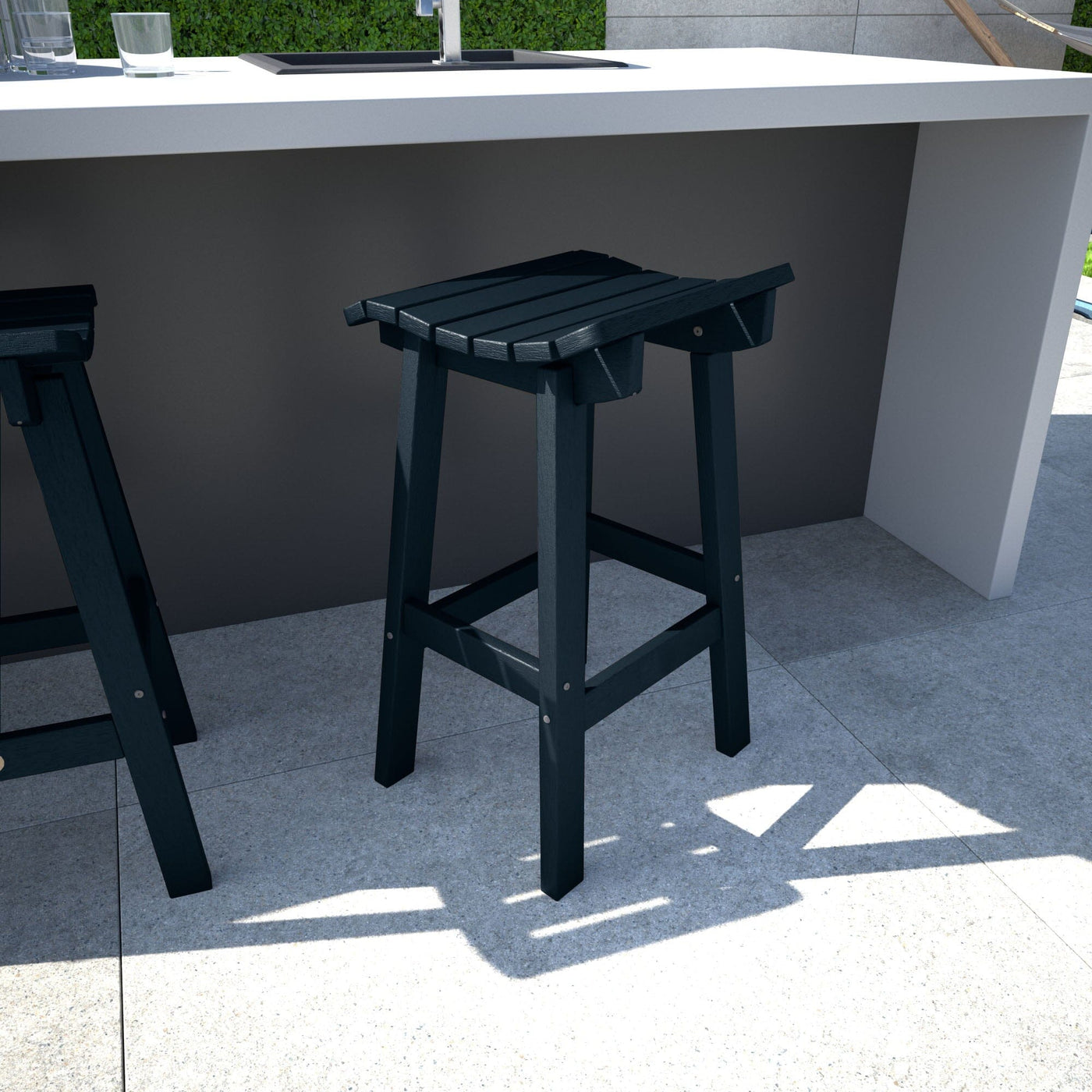 Dark blue Summit Bar Stool in outdoor kitchen area
