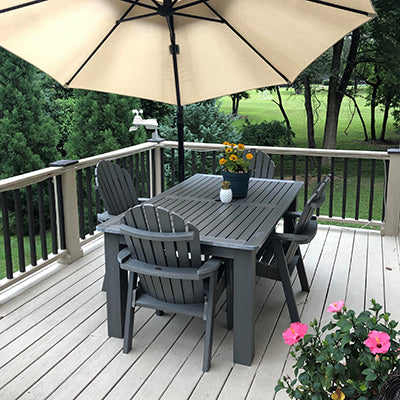 Gray Hamilton Dining set with umbrella on white deck. 