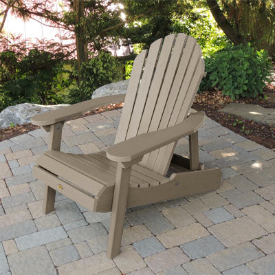 Light brown Hamilton Adirondack chair on paved stones.