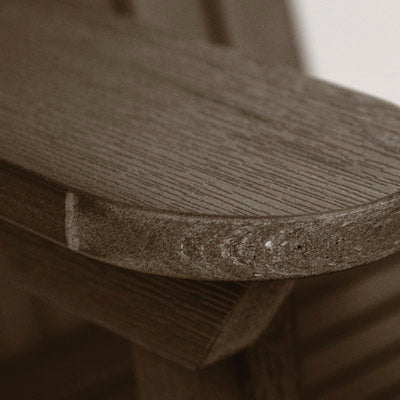 Close up of brown Adirondack chair armrest. 