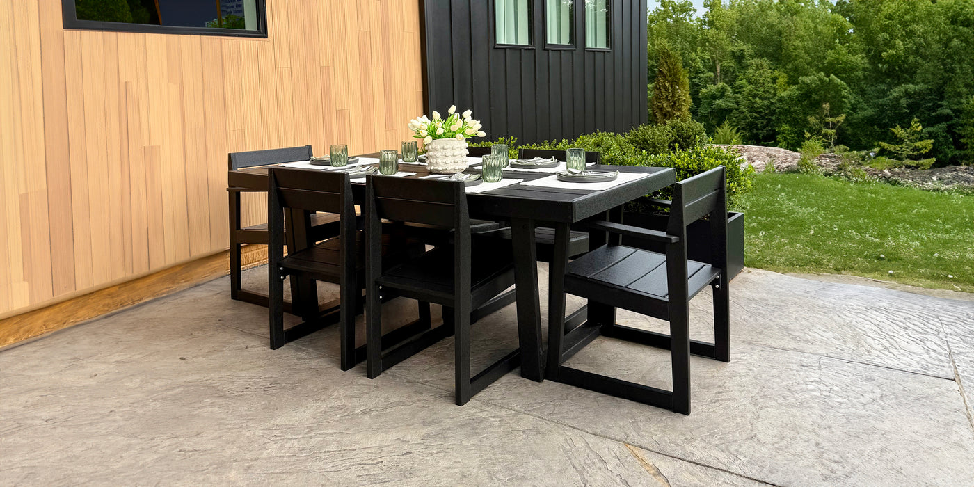 Black outdoor dining set with table and chairs on a patio.