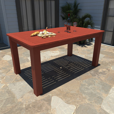 Red rectangular dining table on stone patio. 