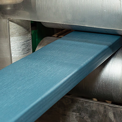 Plank of blue Highwood material in industrial machinery. 