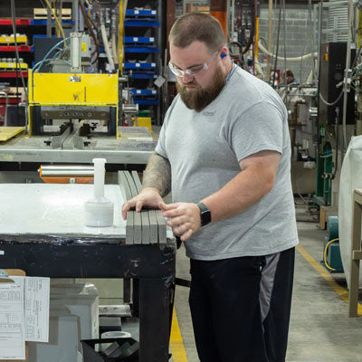 Man working with Highwood boards in manufacturing plant. 