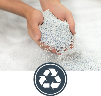 Hands holding white plastic pellets with a recycling symbol overlay on a light gray background