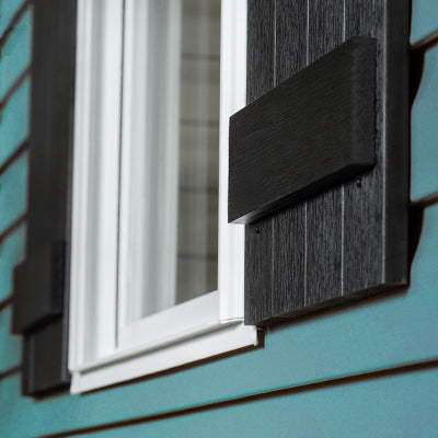 Black Highwood shutters on blue paneled house. 
