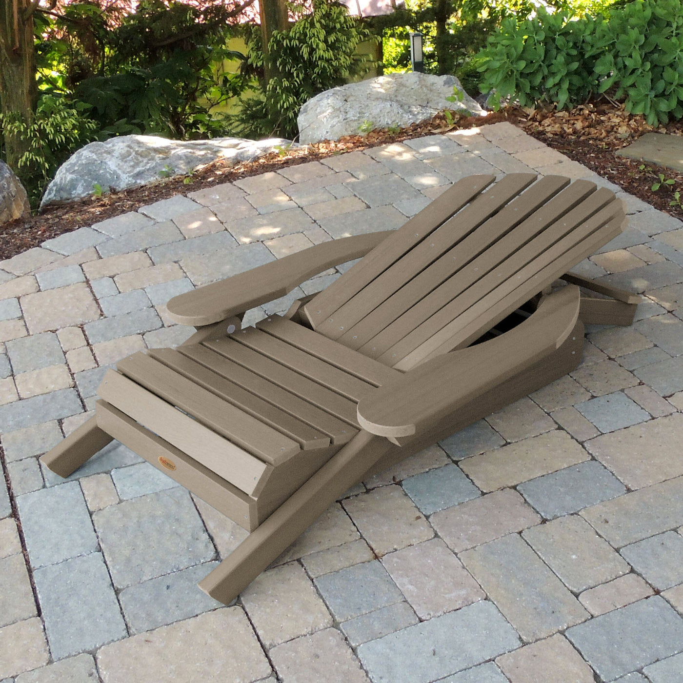 Folded Hamilton Adirondack chair in Woodland brown on stone