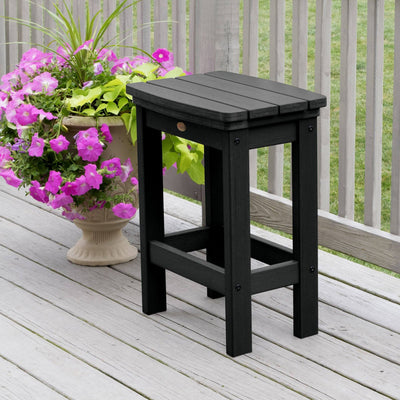 Black Lehigh counter height stool on deck with flowers 
