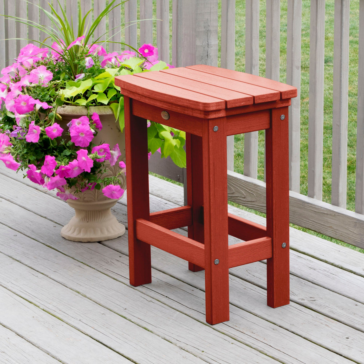 Rustic Red Lehigh counter height stool on deck with flowers 