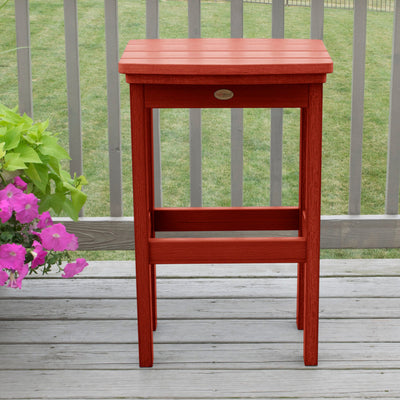 Rustic Red Lehigh bar height stool on deck with flowers 