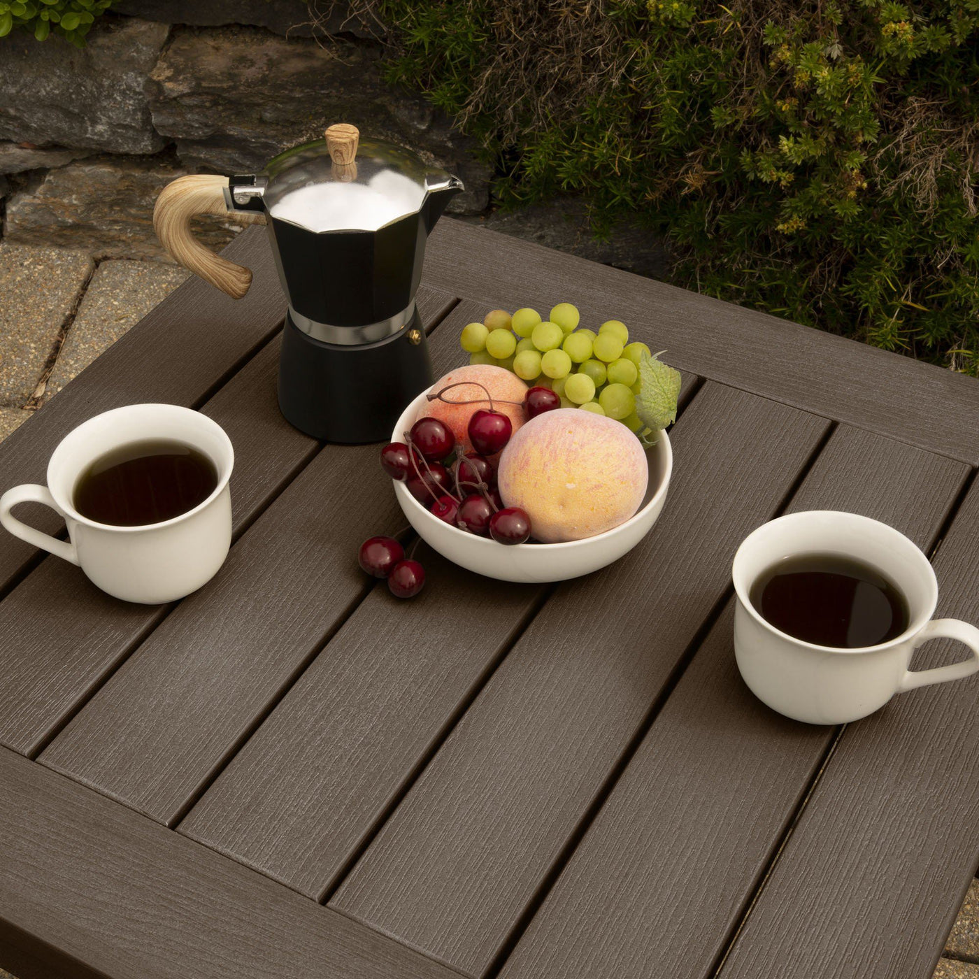 Top-down view of table with cups and fruit
