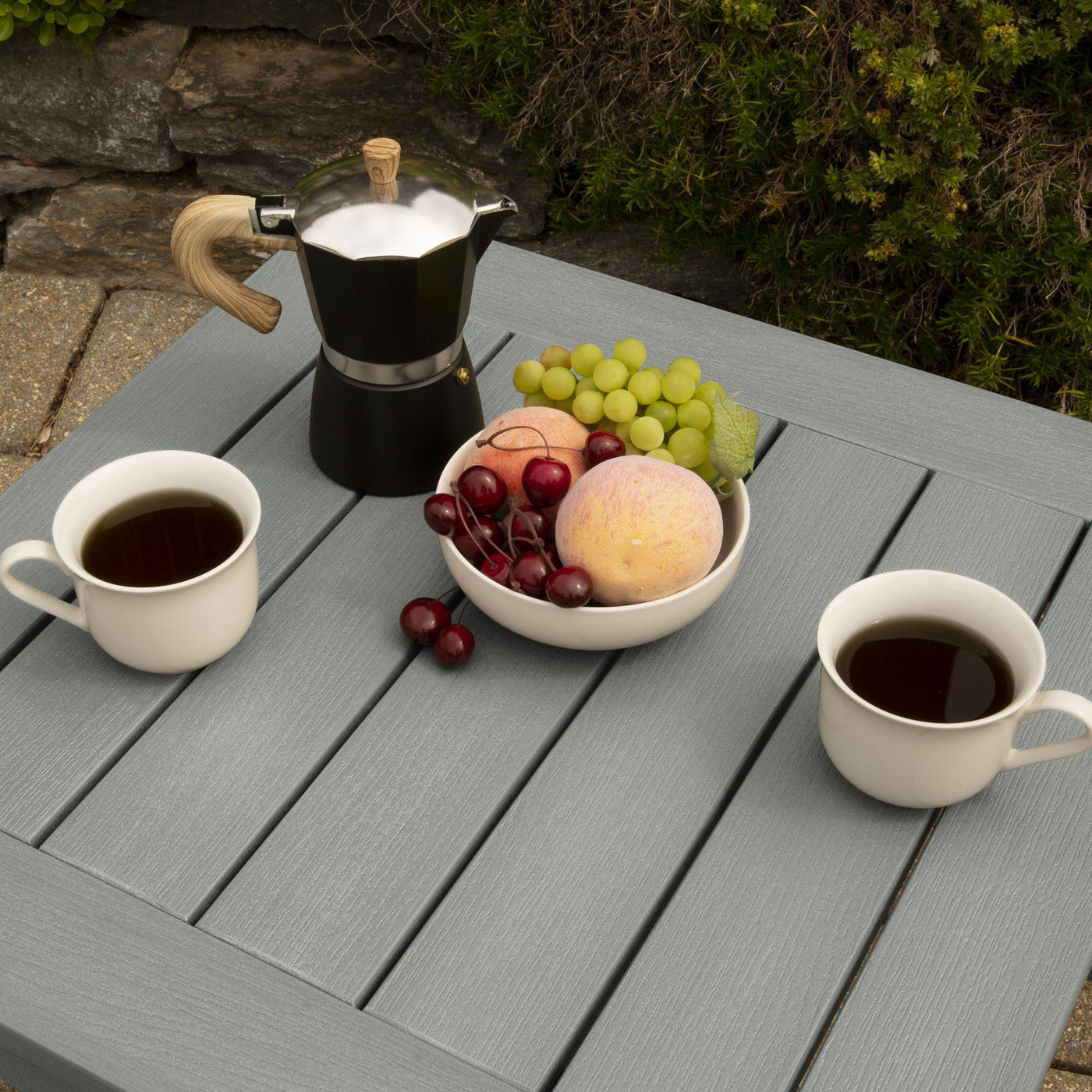 Table with fruit and two cups