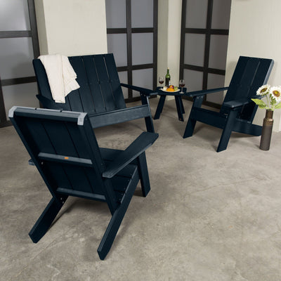 Dark blue Italica 4-piece set on porch with decorations and wine. 