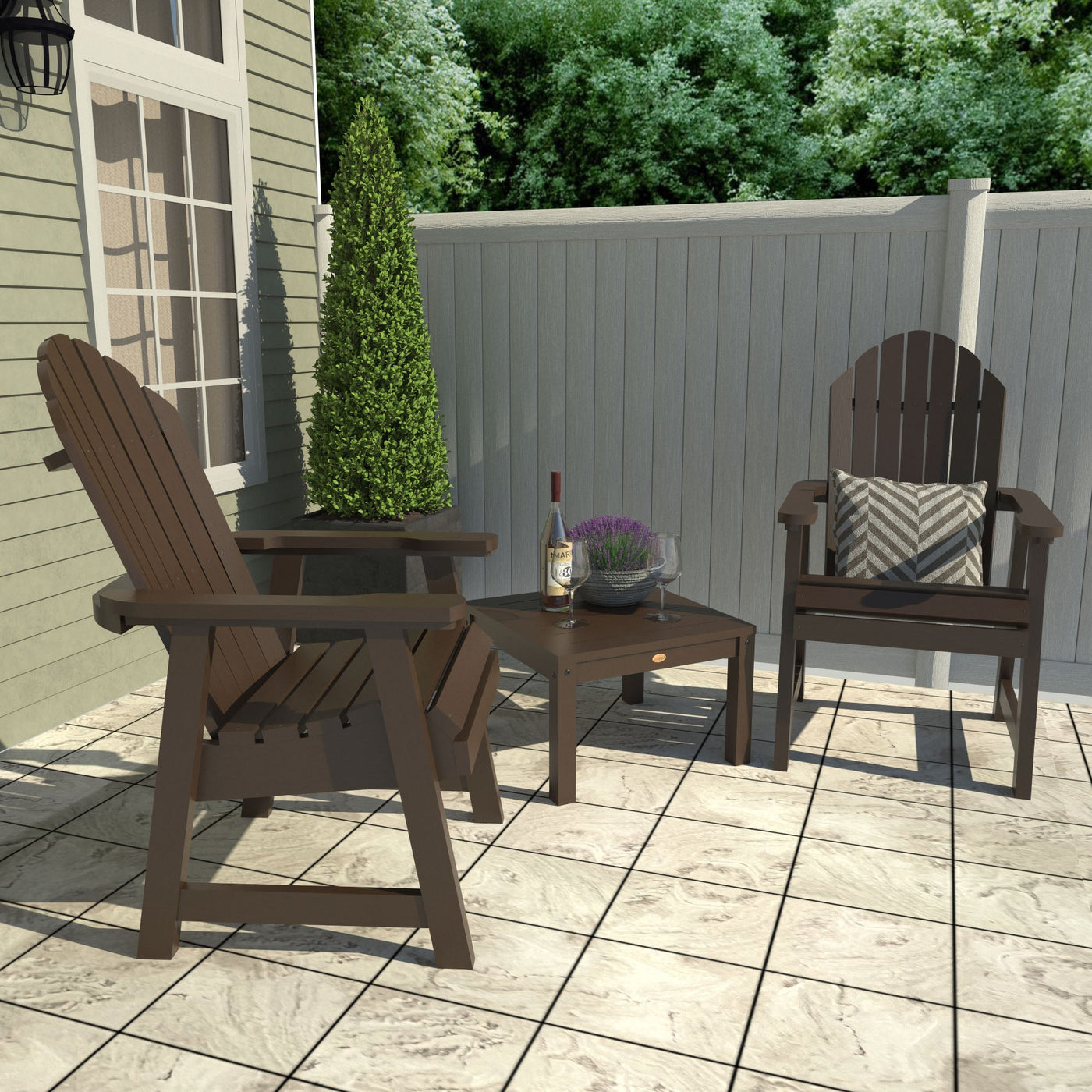 Outdoor patio set with two Adirondack chairs and a small table