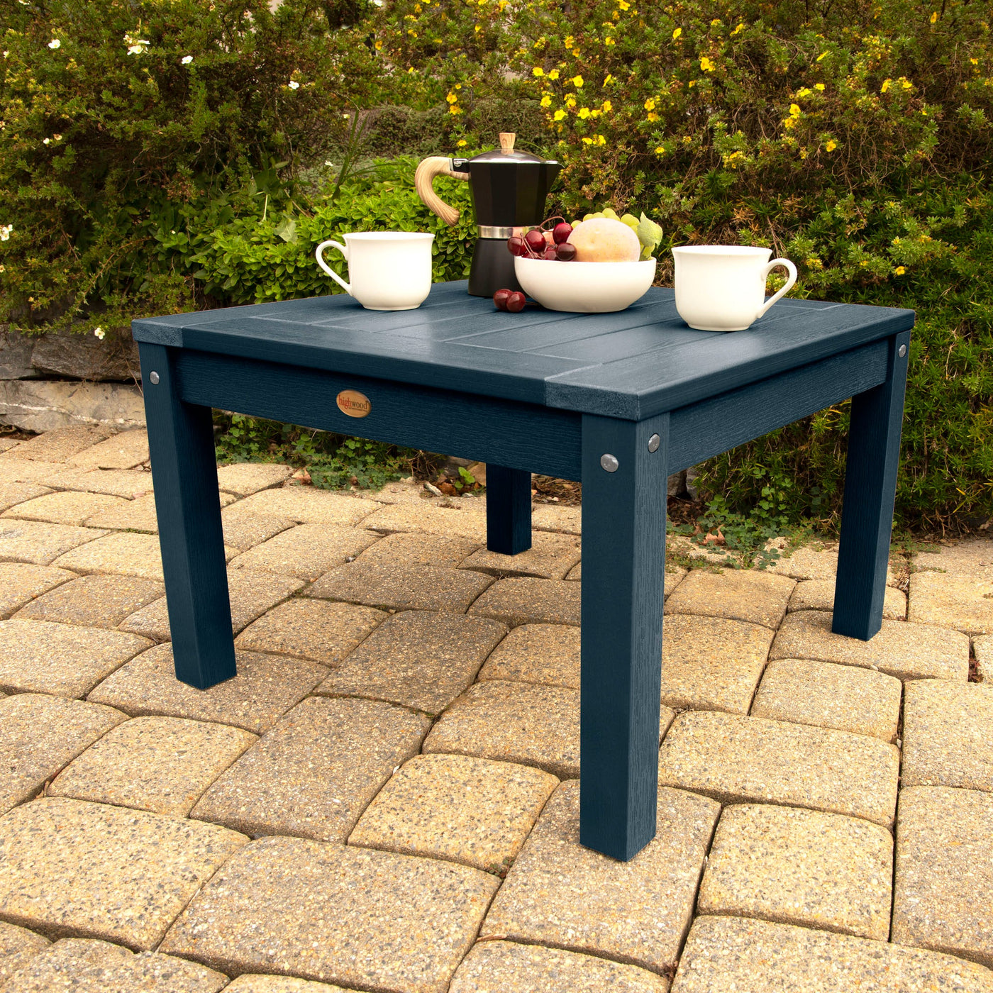 Table and chairs on outdoor surface in dark blue color